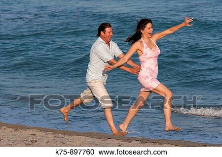 Couple at beach View Large Photo Image Stock Image - Couple at beach. Fotosearch