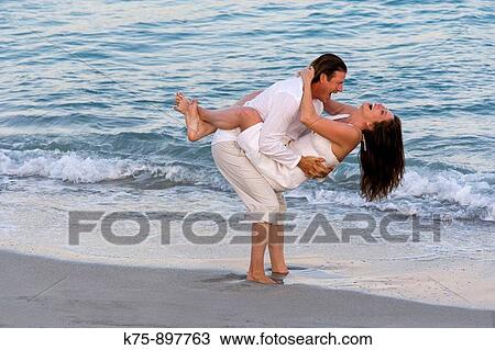 Couple at beach View Large Photo Image Stock Image - Couple at beach. Fotosearch