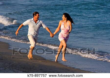 Stock Photo - Couple at beach. Fotosearch