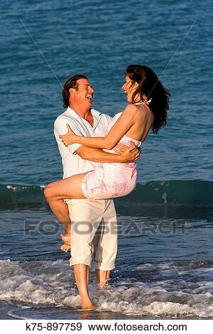 Couple at beach View Large Photo Image Stock Photo - Couple at beach. Fotosearch