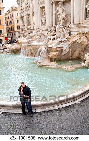 Stock Photo - Couple at Fontana di Trevi in Rome Italy. Fotosearch
