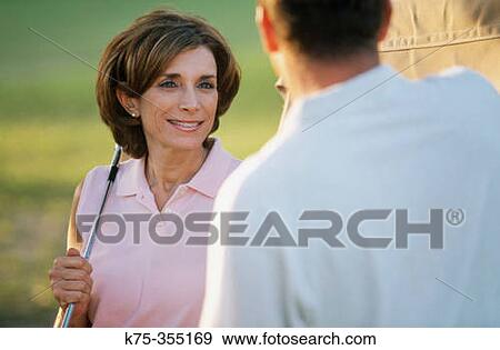 Couple at golf course View Large Photo Image Stock Photo - Couple at golf course. Fotosearch
