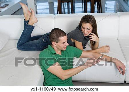Couple at home enjoying leisure time View Large Photo Image Stock Photo - Couple at home enjoying leisure time. Fotosearch