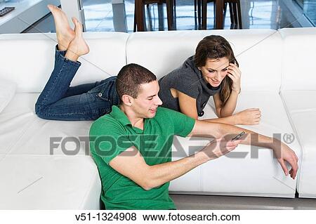 Couple at home enjoying leisure time View Large Photo Image Stock Photo - Couple at home enjoying leisure time. Fotosearch