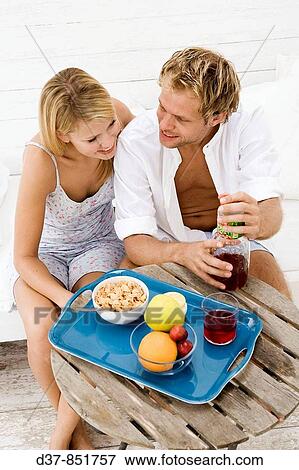 Couple at home having breakfast View Large Photo Image Stock Photo - Couple at home having breakfast. Fotosearch