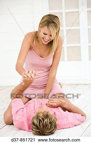 Stock Image - Couple at home joking and looking eachother. Fotosearch