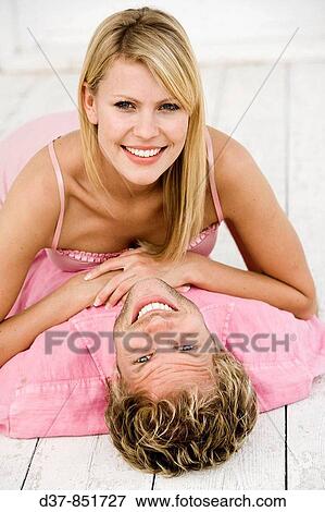 Stock Photo - Couple at home looking at the camera happy. Fotosearch