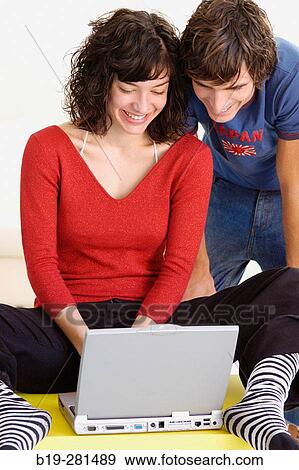 Couple at home with laptop View Large Photo Image Stock Photo - Couple at home with laptop. Fotosearch