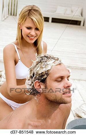 Stock Photo - Couple at home wshing hair. Fotosearch