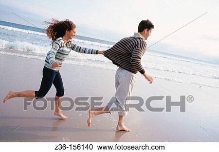 Couple at the beach View Large Photo Image Stock Image - Couple at the beach. Fotosearch
