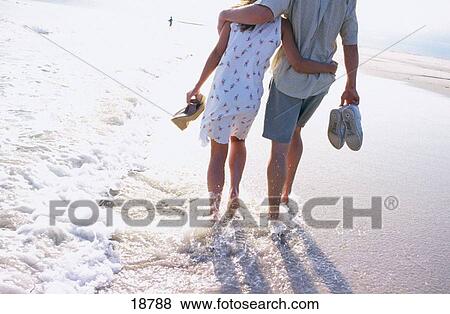 Couple at the beach View Large Photo Image Stock Photo - Couple at the beach. Fotosearch