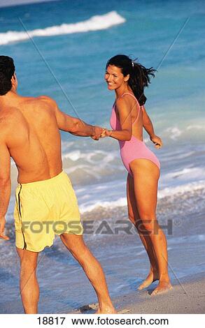 Couple at the beach View Large Photo Image Stock Photo - Couple at the beach. Fotosearch