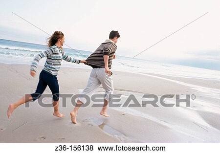 Couple at the beach View Large Photo Image Stock Photo - Couple at the beach. Fotosearch