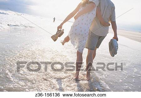 Stock Photograph - Couple at the beach. Fotosearch