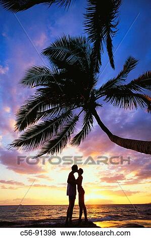 Couple at the beach, sunset View Large Photo Image Stock Photo - Couple at the beach, sunset. Fotosearch