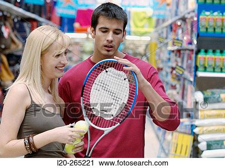 Couple at the sports section of a shopping center View Large Photo Image Stock Image - Couple at the sports section of a shopping center. Fotosearch