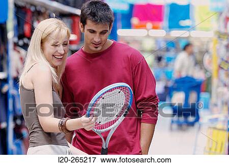 Couple at the sports section of a shopping center View Large Photo Image Stock Photo - Couple at the sports section of a shopping center. Fotosearch
