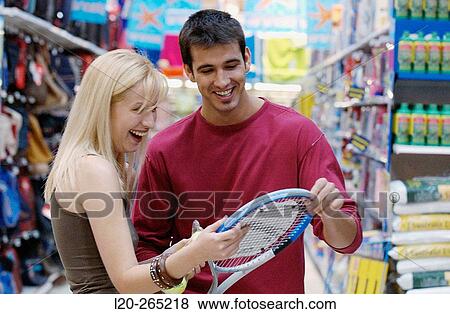 Couple at the sports section of a shopping center View Large Photo Image Stock Photo - Couple at the sports section of a shopping center. Fotosearch