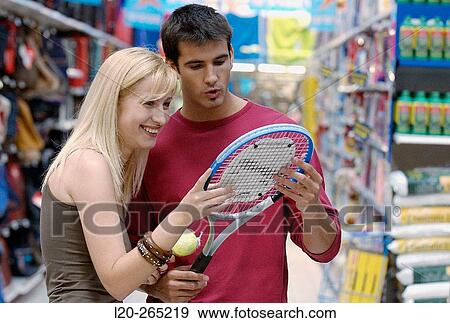 Couple at the sports section of a shopping center View Large Photo Image Stock Photo - Couple at the sports section of a shopping center. Fotosearch