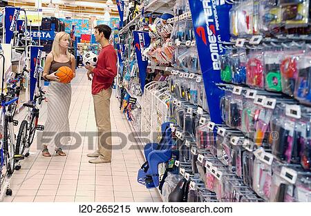 Couple at the sports section of a shopping center View Large Photo Image Stock Photography - Couple at the sports section of a shopping center. Fotosearch