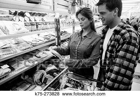 Couple at the supermarket View Large Photo Image Stock Photo - Couple at the supermarket. Fotosearch