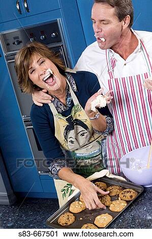 Couple baking in the kitchen. View Large Photo Image Stock Image - Couple baking in the kitchen.. Fotosearch