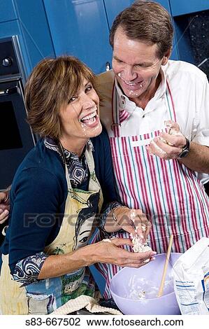 Couple baking in the kitchen. View Large Photo Image Stock Image - Couple baking in the kitchen.. Fotosearch