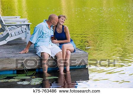 couple being affectionate on dock View Large Photo Image Stock Photograph - couple being affectionate on dock. Fotosearch