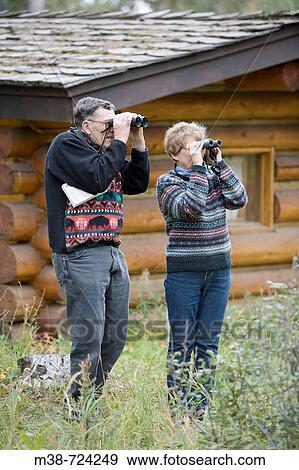 Couple bird watching, Lone Mt Ranch, Big Sky, Montana, USA View Large Photo Image Stock Photo - Couple bird watching, Lone Mt Ranch, Big Sky, Montana, USA. Fotosearch