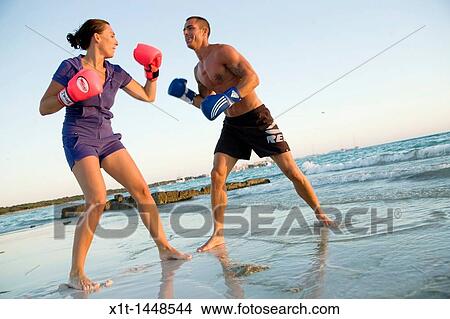 Couple boxing on the beach View Large Photo Image Picture - Couple boxing on the beach. Fotosearch