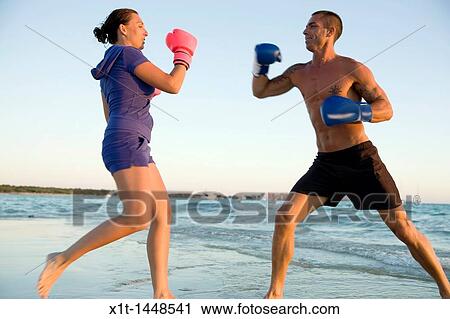 Couple boxing on the beach View Large Photo Image Stock Image - Couple boxing on the beach. Fotosearch