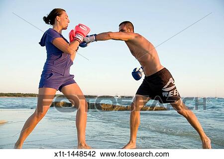 Stock Image - Couple boxing on the beach. Fotosearch