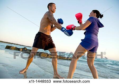 Couple boxing on the beach View Large Photo Image Stock Image - Couple boxing on the beach. Fotosearch
