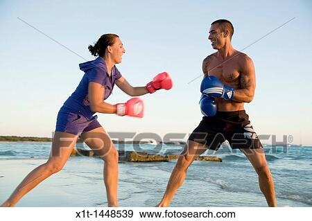 Couple boxing on the beach View Large Photo Image Stock Photo - Couple boxing on the beach. Fotosearch