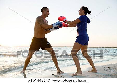 Couple boxing on the beach View Large Photo Image Stock Photo - Couple boxing on the beach. Fotosearch