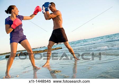 Couple boxing on the beach View Large Photo Image Stock Photography - Couple boxing on the beach. Fotosearch