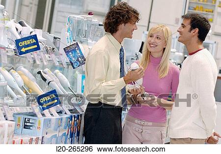 Couple buying a hand blender at shopping center View Large Photo Image Stock Photograph - Couple buying a hand blender at shopping center. Fotosearch
