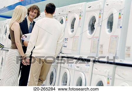 Couple buying a washing machine View Large Photo Image Picture - Couple buying a washing machine. Fotosearch