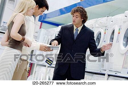 Couple buying a washing machine View Large Photo Image Stock Photo - Couple buying a washing machine. Fotosearch