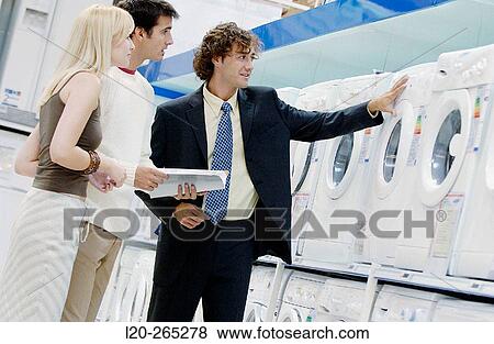 Couple buying a washing machine View Large Photo Image Stock Photo - Couple buying a washing machine. Fotosearch