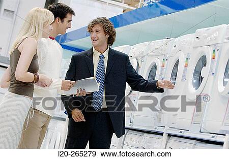 Couple buying a washing machine View Large Photo Image Stock Photo - Couple buying a washing machine. Fotosearch