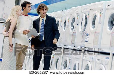 Couple buying a washing machine View Large Photo Image Stock Photo - Couple buying a washing machine. Fotosearch