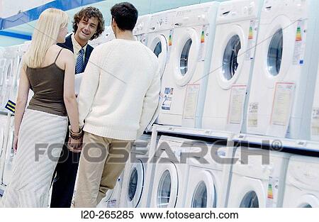 Couple buying a washing machine View Large Photo Image Stock Photography - Couple buying a washing machine. Fotosearch