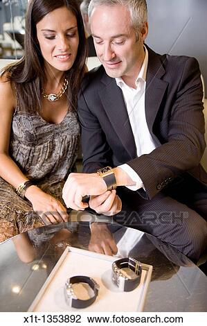 Stock Image - Couple buying a wristwatch. Fotosearch