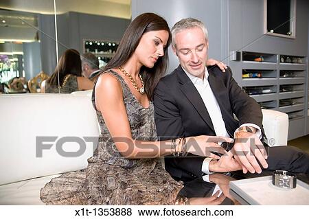 Couple buying a wristwatch View Large Photo Image Stock Photo - Couple buying a wristwatch. Fotosearch