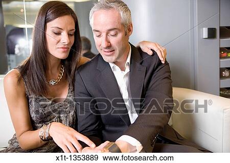 Couple buying a wristwatch View Large Photo Image Stock Photo - Couple buying a wristwatch. Fotosearch