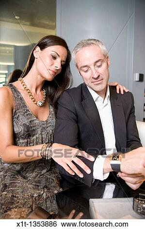 Couple buying a wristwatch View Large Photo Image Stock Photograph - Couple buying a wristwatch. Fotosearch