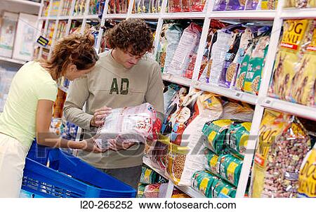 Couple buying dog food at shopping center View Large Photo Image Stock Image - Couple buying dog food at shopping center. Fotosearch