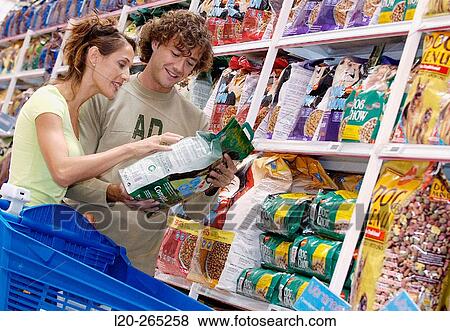 Couple buying dog food at shopping center View Large Photo Image Stock Photo - Couple buying dog food at shopping center. Fotosearch
