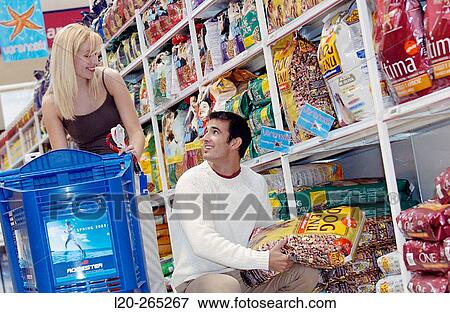 Couple buying dog food at shopping center View Large Photo Image Stock Photo - Couple buying dog food at shopping center. Fotosearch
